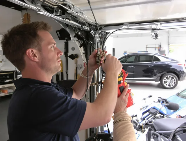 North Ridgeville Garage Door Repair safety certified technician performing cable replacement in North Ridgeville